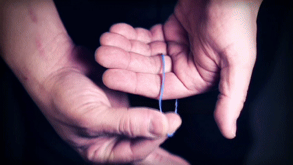 performance of tru Xtreme rubber band going through objects and spectators fingers