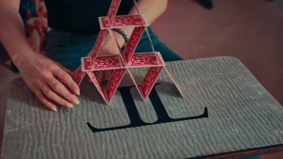 Building a house of cards with premium playing cards – available at 52Kards.