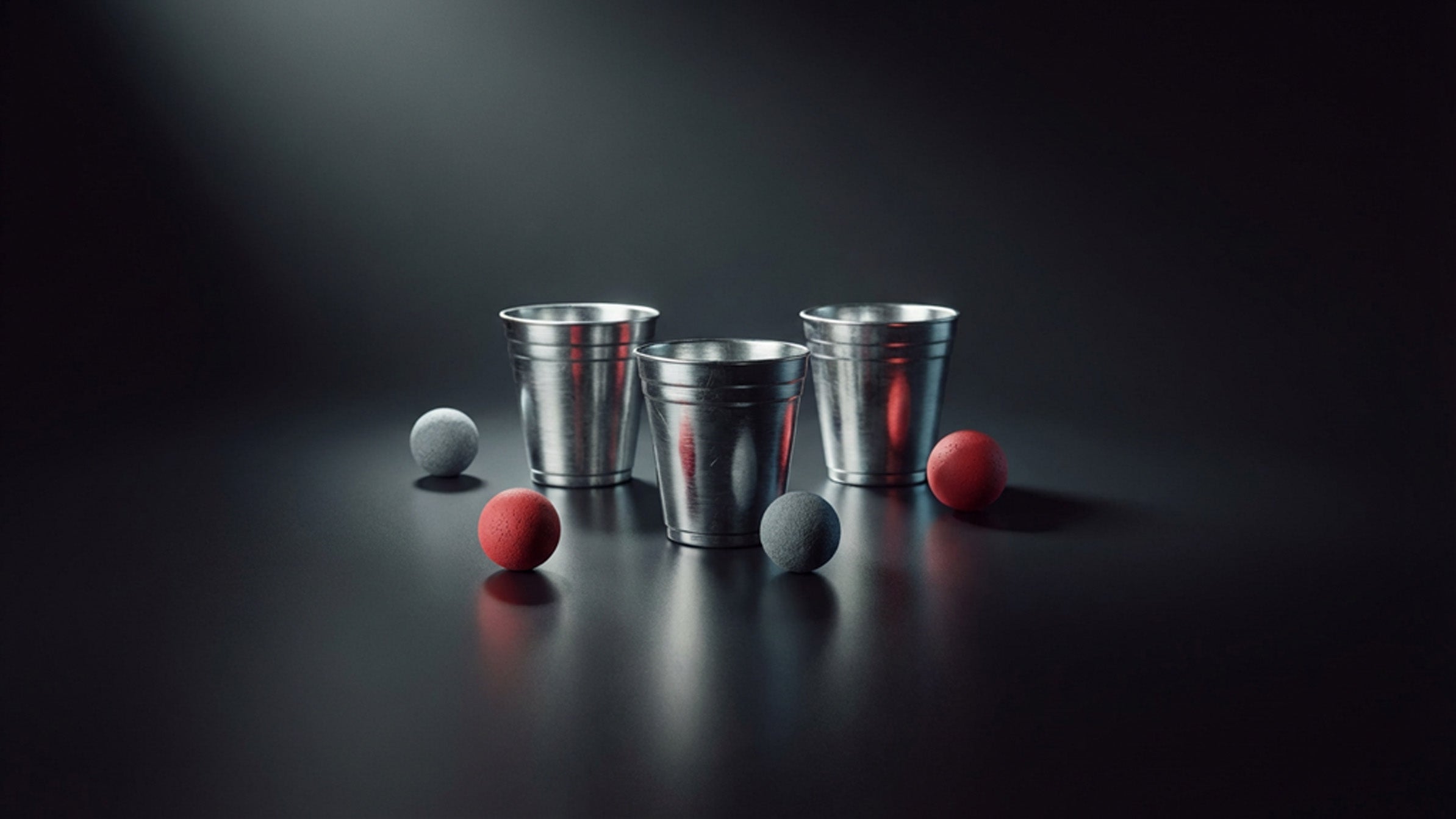 Three polished magician's cups and colorful balls arranged elegantly on a softly lit surface, accented by a sprinkle of magical sparkles — embodying the timeless art of the Cups and Balls routine, brought to you by 52Kards.