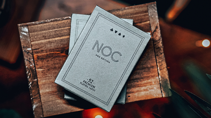 Two greystone NOC Pro tuck boxes overlapping on a wooden surface