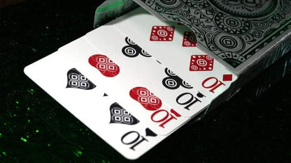 Playing cards with red and black symbols on a dark surface