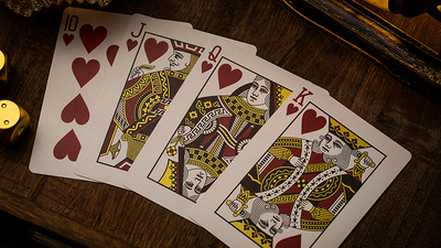 NOC Luxury Ten, Jack, Queen, and King of Hearts fanned on a wooden surface