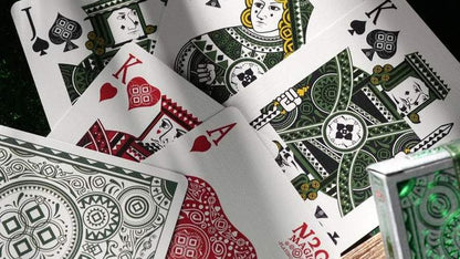 Playing cards with intricate designs on a dark surface
