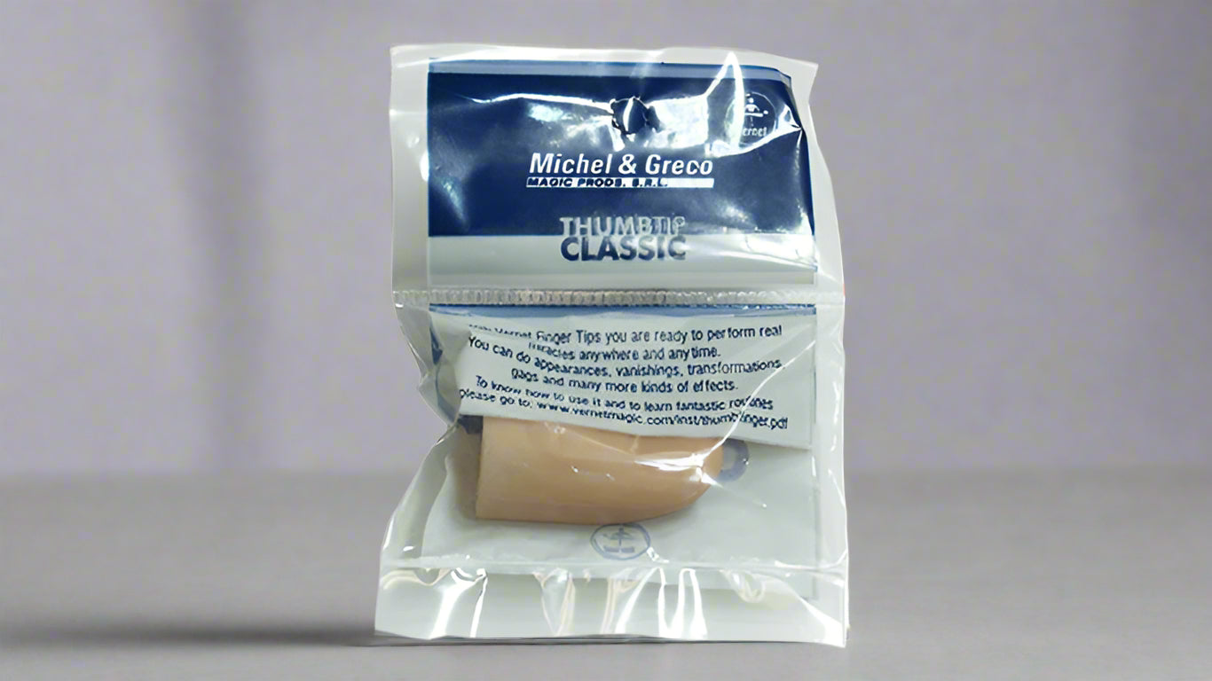 Close-up of a packaged Michel & Greco Vernet Thumbtip Classic, a versatile magic prop for performing tricks such as vanishes, transformations, and appearances. The clear packaging displays the thumbtip and product details, with a simple and professional design.