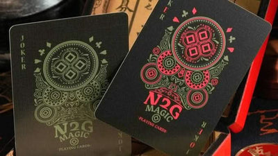 Black coinpix playing cards with red and green designs on a vintage-style box