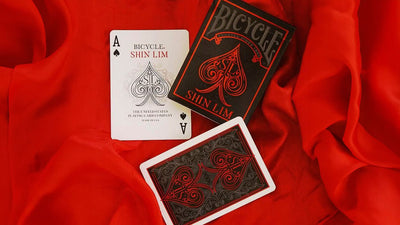 Bicycle Shin Lim Ace of Spades and red card back beside a matching tuck box