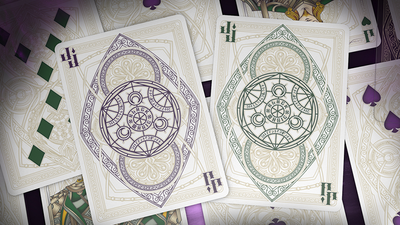 Purple and green Bicycle Black Magic card backs overlapping on face-up cards