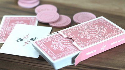 Black Roses Altrosa tuck box, pink-backed cards, face-up card, and round stickers on a table