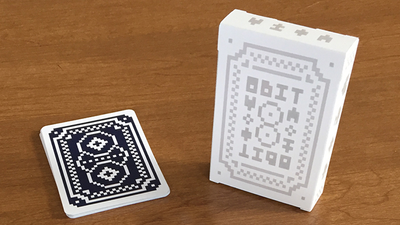 White 8 Bit tuck box standing beside a squared deck with a pixel-style card back