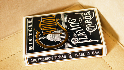Close-up of the Bicycle Capitol tuck box lying on a tan seat