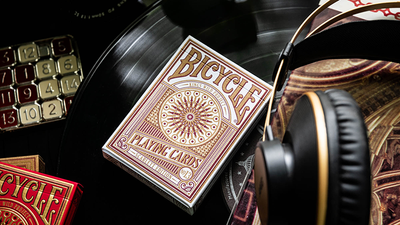 Bicycle Scarlett tuck box lying among headphones, a vinyl record and audio equipment