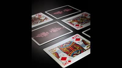 Black and pink Casino Femme Fatale card backs scattered with face-up diamond court cards