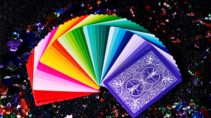 Bicycle Rainbow cards in a multicolored fan beside a purple card back